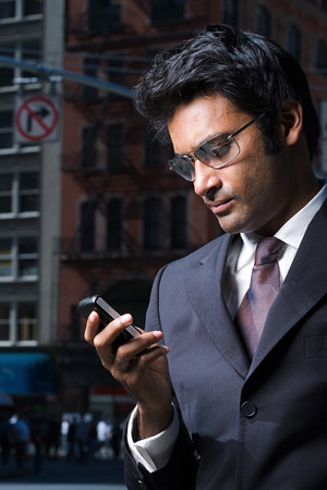 Businessman reading a text messageの写真素材