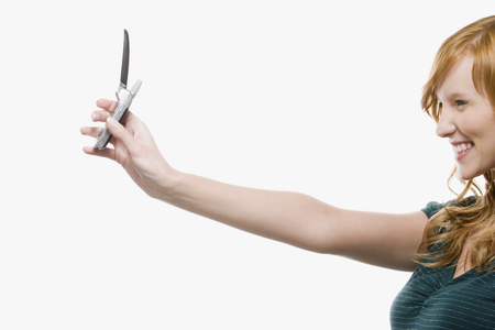 Woman photographing with cell phoneの写真素材