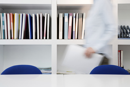 Person moving through officeの写真素材