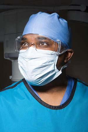 Surgeon in mask and safety gogglesの写真素材