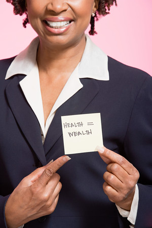 Woman holding an adhesive noteの写真素材