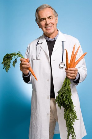 Doctor holding carrotsの写真素材