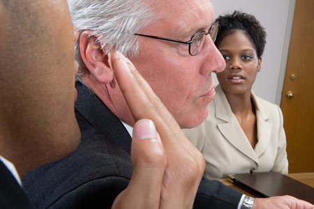 Man whispering in interviewの写真素材