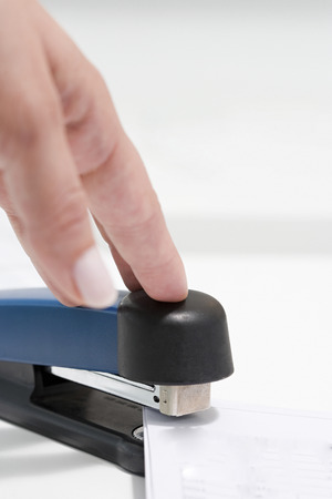 Person using staplerの写真素材