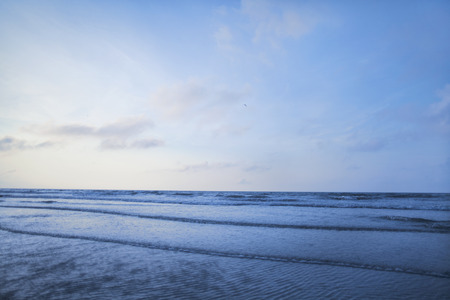 View of beach and waves at sunrise
