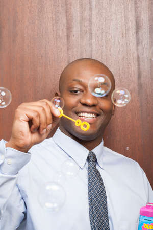 Office person blowing bubblesの写真素材