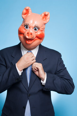 Businessman with pig maskの写真素材