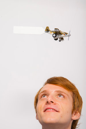 Man watching airplane with sign