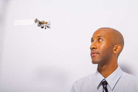 Man watching airplane with signの写真素材