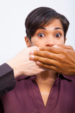 Woman with mouth coveredの写真素材