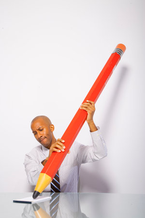 Man writing with large pencilの写真素材