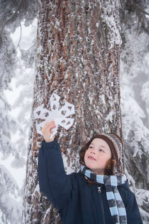 Child holding snowflakeの写真素材