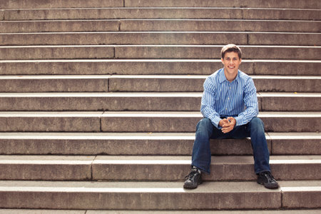 Teenager posing on stairsの写真素材
