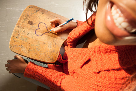 College student writing on desk