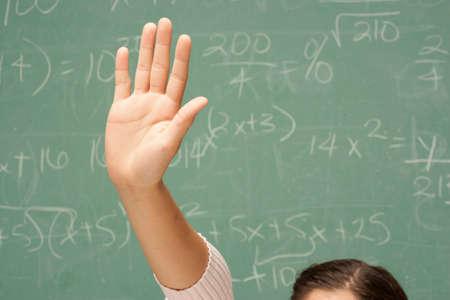 Student's hand raised in classroom