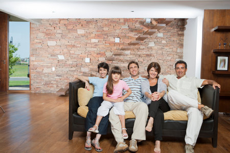 Hispanic family sitting in living roomの写真素材