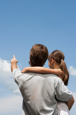 Father and daughter pointing to cloudsの写真素材