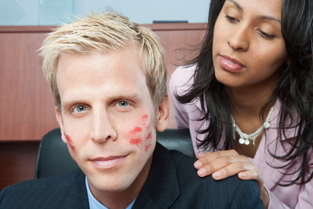 Woman seducing man in officeの写真素材