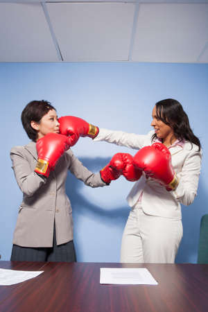Coworkers punching each other in officeの写真素材