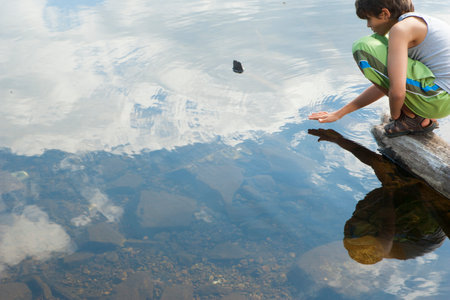 Boy next to lake in natural settingの写真素材