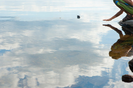 Boy next to lake in natural settingの写真素材