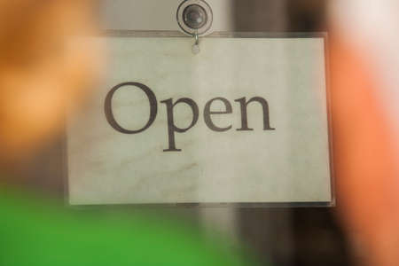 Viewing an open sign in a store window