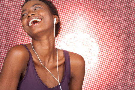Young woman with earphones in studioの写真素材