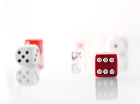 Red and white dice counters on white backgroundの写真素材