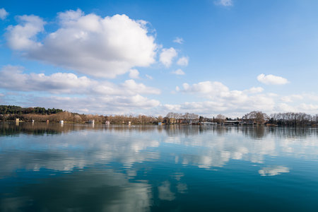 Reflection of the clouds and the blue sky on the water of Lake Banyoles.の写真素材