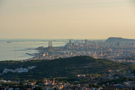 Panoramic view of the entire city of Barcelona and its surroundings. During sunset one day in late summer. We can see the Mediterranean sea completely flat.の写真素材