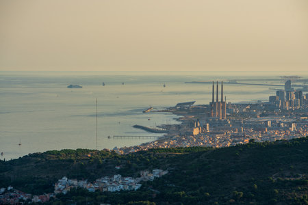 Panoramic view of the entire city of Barcelona and its surroundings. During sunset one day in late summer. We can see the Mediterranean sea completely flat.の写真素材