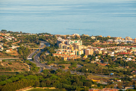 Panoramic view of the Maresme coast, north coast of the city of Barcelona. During sunset one day in late summer. We can see the Mediterranean sea completely flat.の写真素材