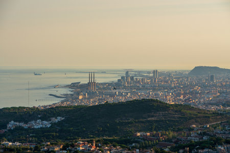Panoramic view of the entire city of Barcelona and its surroundings. During sunset one day in late summer. We can see the Mediterranean sea completely flat.の写真素材