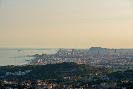 Panoramic view of the entire city of Barcelona and its surroundings. During sunset one day in late summer. We can see the Mediterranean sea completely flat.の写真素材