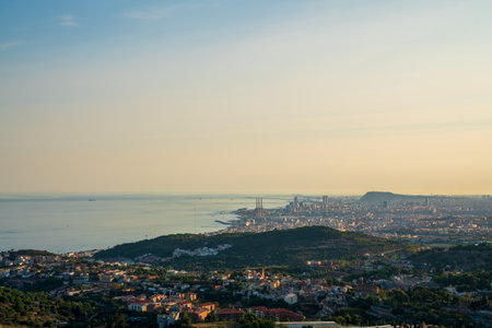Panoramic view of the entire city of Barcelona and its surroundings. During sunset one day in late summer. We can see the Mediterranean sea completely flat.の写真素材