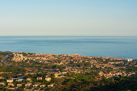 Panoramic view of the Maresme coast, north coast of the city of Barcelona. During sunset one day in late summer. We can see the Mediterranean sea completely flat.の写真素材
