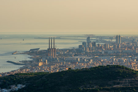 Panoramic view of the entire city of Barcelona and its surroundings. During sunset one day in late summer. We can see the Mediterranean sea completely flat.の写真素材