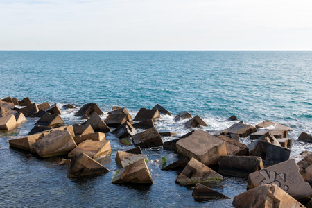 Artificial rocks forming a breakwater. Mediterranean sea, a sunny winter dayの写真素材