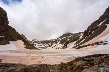 Estany de la Gola. On an early spring day. Completely frozen. Dirty mud snow from the suspended dust of the Sahara desert.の写真素材