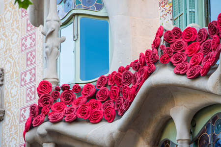 BARCELONA, SPAIN, APRIL 23, 2021: Casa Batllo in Barcelona, one of the most beautiful houses on Passeig de Gracia. By the architect Antoni Gaudi. Decorated with roses for St. Georges Day.のeditorial素材
