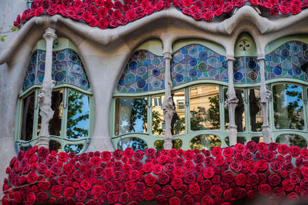 BARCELONA, SPAIN, APRIL 23, 2021: Casa Batllo in Barcelona, one of the most beautiful houses on Passeig de Gracia. By the architect Antoni Gaudi. Decorated with roses for St. Georges Day.のeditorial素材
