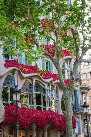 BARCELONA, SPAIN, APRIL 23, 2021: Casa Batllo in Barcelona, one of the most beautiful houses on Passeig de Gracia. By the architect Antoni Gaudi. Decorated with roses for St. Georges Day.のeditorial素材