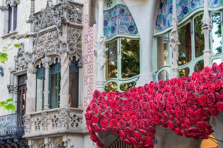 BARCELONA, SPAIN, APRIL 23, 2021: Casa Batllo in Barcelona, one of the most beautiful houses on Passeig de Gracia. By the architect Antoni Gaudi. Decorated with roses for St. Georges Day.のeditorial素材