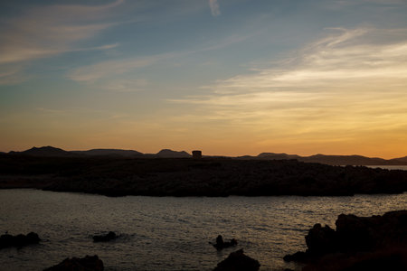 Cala Viola de Ponent, Menorca. September 2021. Magnificent sunset in the Mediterranean Sea. On one of the paradisaical beaches of the island of Menorca.の写真素材