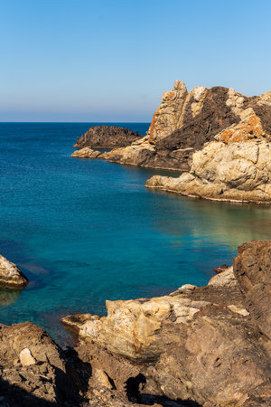 Cap de Creus Alt Emporda, Spain. February 2023 Rugged rocky coastline with turquoise waters in contrast. Sharp rocks extend out to the sea, creating a dramatic and wild texture.の写真素材