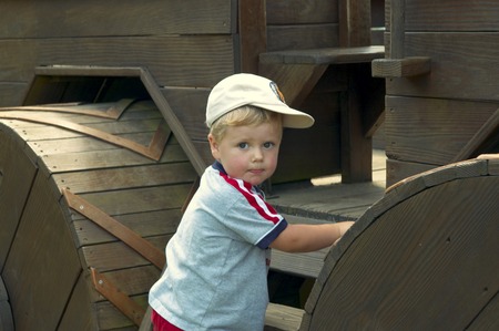 A Young Boy starting to explore new toys on the playgroundの写真素材