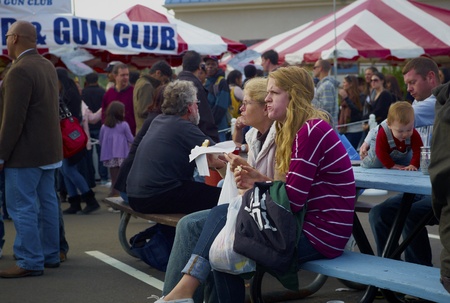 Couple eating at the Oyster Fest in Oyster Bay, NY 10/15/11のeditorial素材