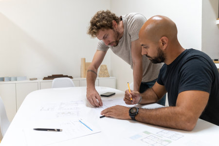 Two young architects working in their studio on a projectの写真素材