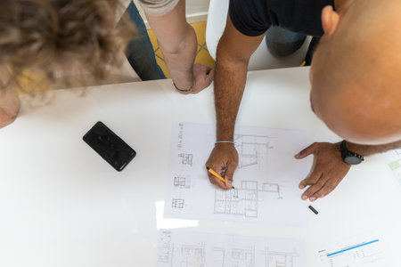 Two young architects working in their studio on a project