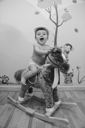 baby on rocking horseの写真素材